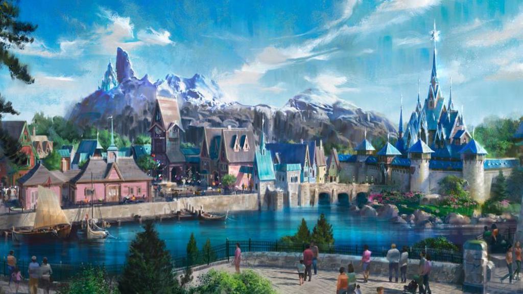 An artist illustration of the World of Frozen area in Disneyland Paris Resort. It shows a glistening ice-topped palace set within a series of looming mountains. Traditional buildings line a lake, where boats are moored.