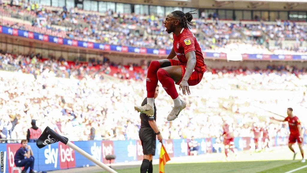 Omari Patrick takes to the air to celebrate his equaliser