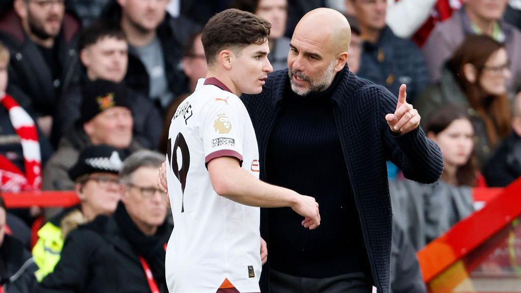 Julian Alvarez receiving instructions from Pep Guardiola