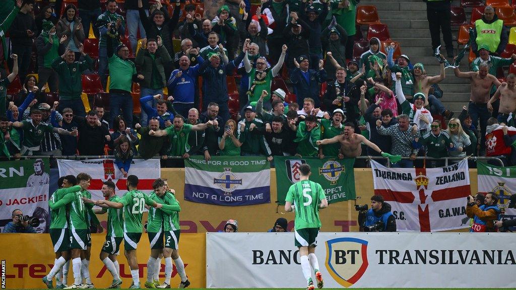 Jamie Reid celebrates his first international goal