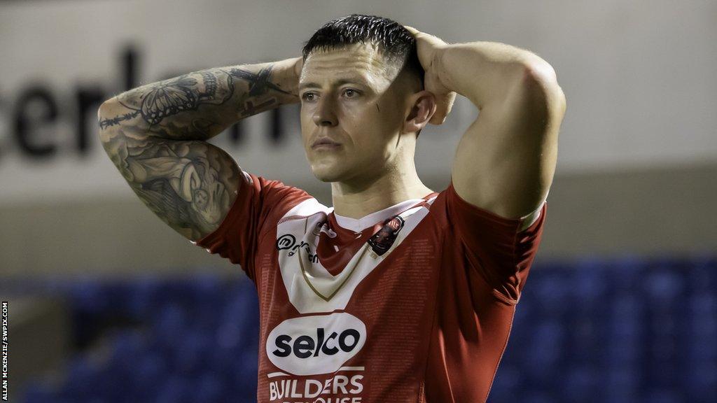 Salford Red Devils player Deon Cross celebrates a try by teammate Ken Sio