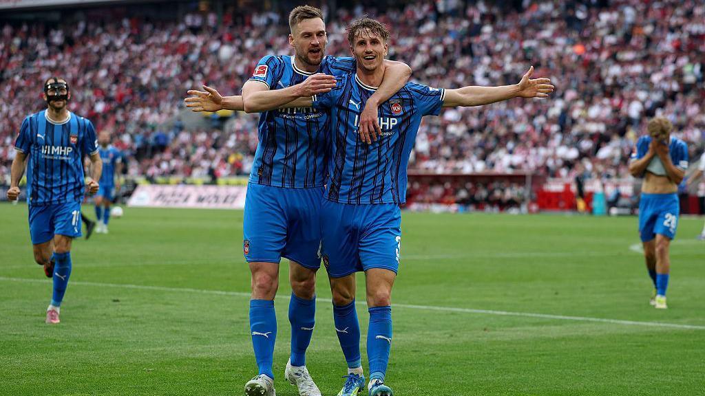 Heidenheim players celebrate their goal against Cologne.