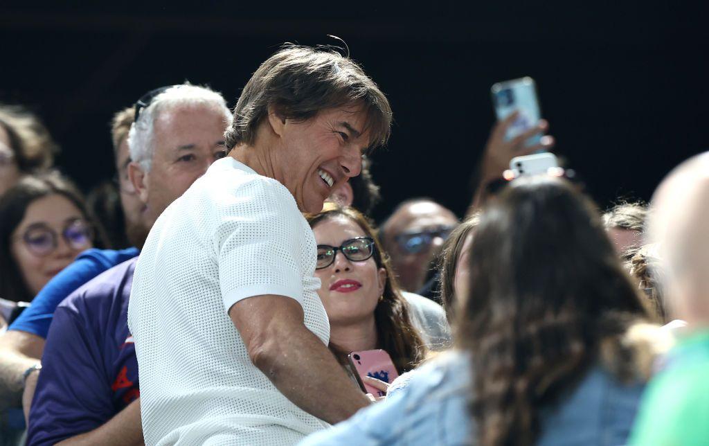 Tom Cruise greets fans during the Artistic Gymnastics Women's Qualification 