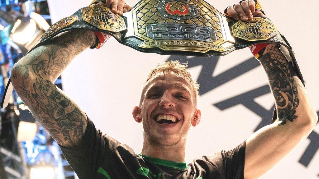 Rhys McKee celebrates with the welterweight belt after defeating Jimmy Wallhead at the 3Arena