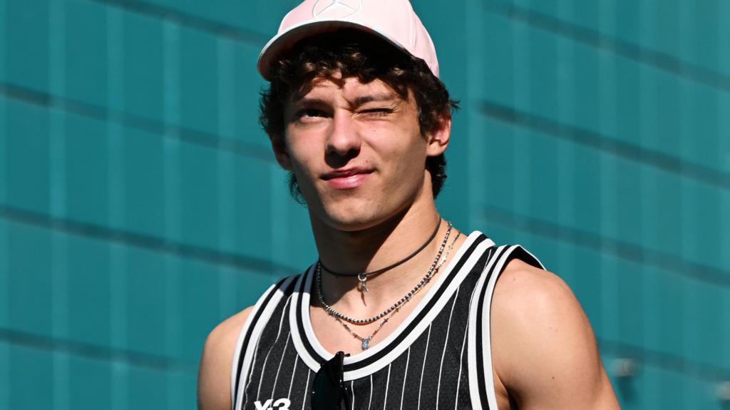 Kimi Antonelli winking and wearing a vest at the Miami Grand Prix