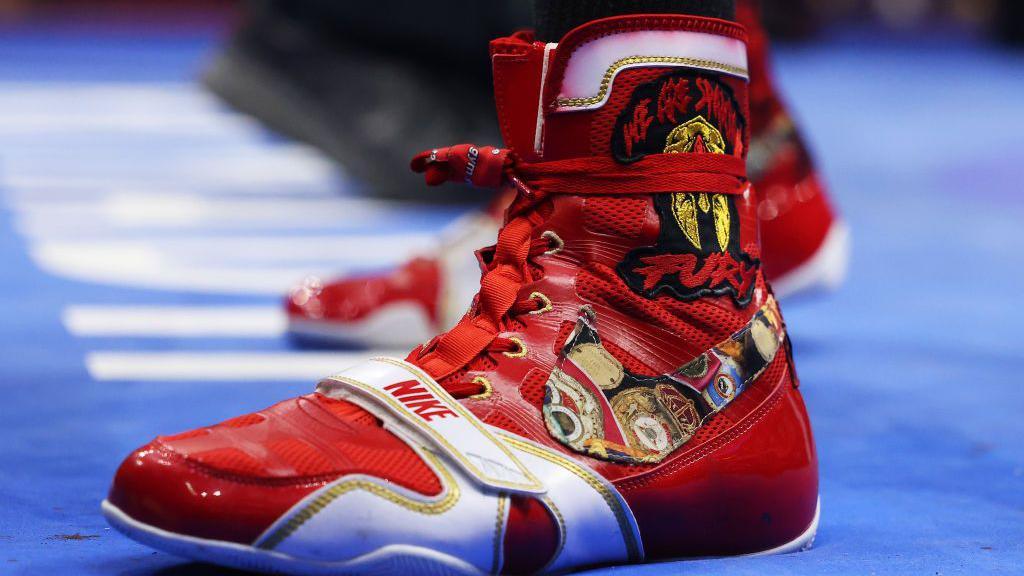 Tyson Fury red boxing boots that say 'We are Spartans' 