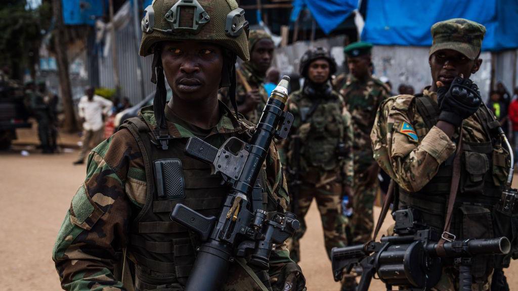 M23 rebels guard a unit of surrendering Congolese police officers who will be recruited into the rebel group on February 22, 2025 in Bukavu, Democratic Republic of Congo.