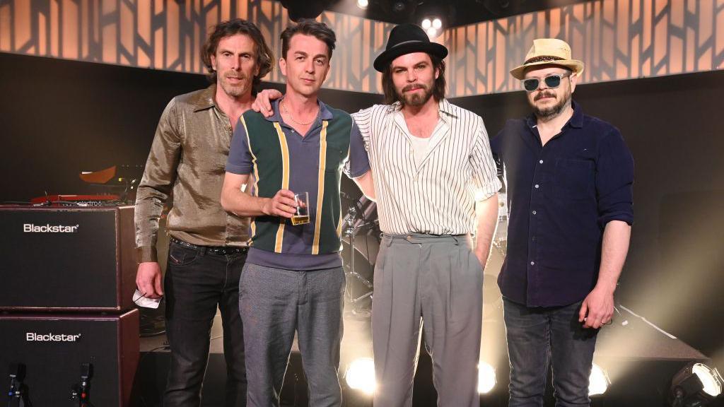 Rob Coombes, Goffey, Gaz Coombes and Quinn on the set of the Jimmy Kimmel talk show in 2022 