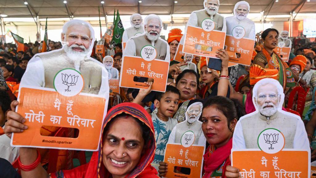 Supporters of Bharatiya Janata Party (BJP) hold cut-outs of India's Prime Minister Narendra Modi during an election campaign rally in New Delhi on May 18, 2024, ahead of the fifth phase of polling in the ongoing country's general election. (Photo by Arun SANKAR / AFP) (Photo by ARUN SANKAR/AFP via Getty Images)