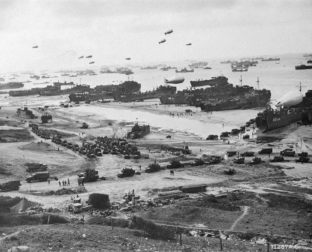 Normandy Beach is shown here during the Allied invasion, June 6, 1944: Ships fill the channel, and balloons float overhead to protect them from the enemy.