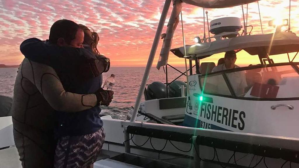 English diver John Craig embraces his wife after surviving a 7.5km swim back to shore