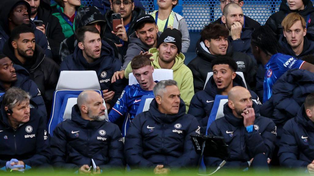 Chelsea's squad sit behind the bench during the win over Aston Villa