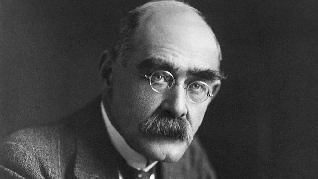 Kipling is wearing glasses and looking into the camera