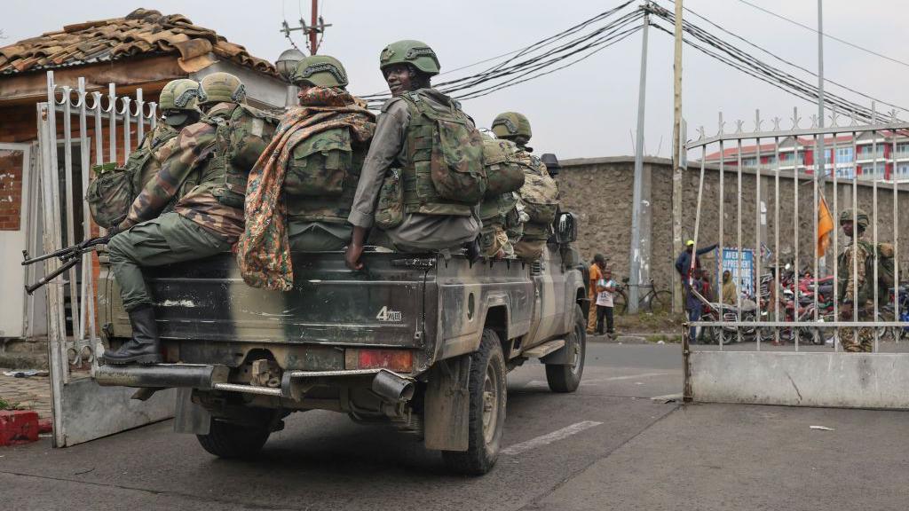 Members of the M23 armed group arrive in a pickup truck at the compound where residents gather for a protest against the Congolese government, expressing support for the M23 armed group in Goma on January 31, 2025.