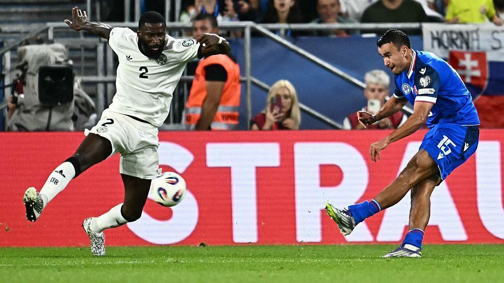 David Strelec shoots to score the second goal for Slovakia in their World Cup qualifier win over Germany