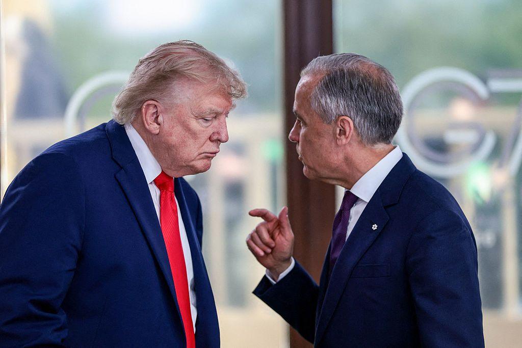 US President Donald Trump speaks with Canada's Prime Minister Mark Carney during a work lunch as part of the G7 summit, in Evian, eastern France, on 16 June 2026.