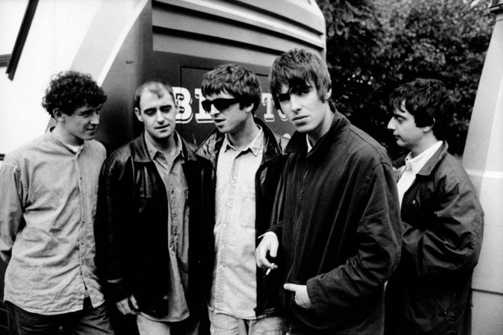 Left to right: Tony McCarroll, Paul "Bonehead" Arthurs, Noel Gallagher, Liam Gallagher, Paul "Guigsy" McGuigan