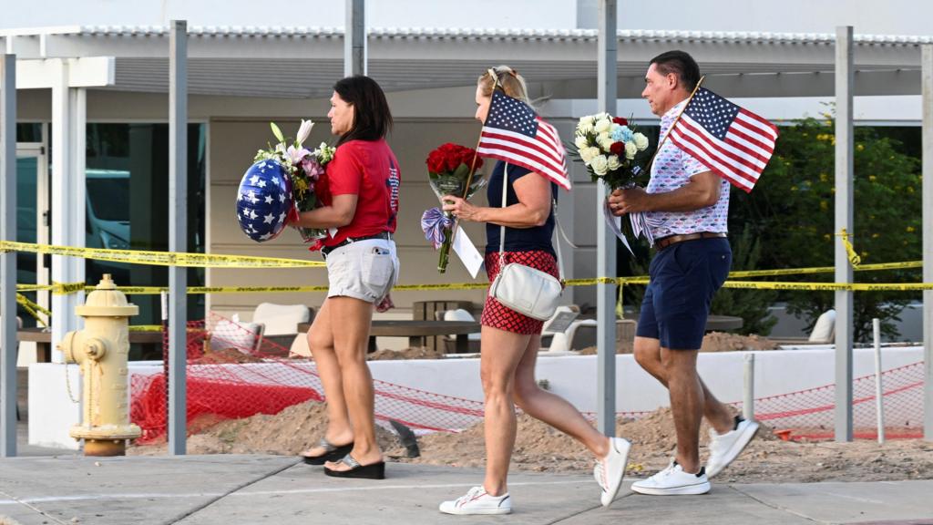  Mourners bring flowers to a memorial for Charlie Kirk