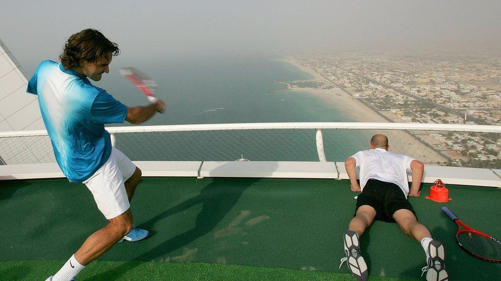 Federer adn Agassi looking out over the edge of a helipad