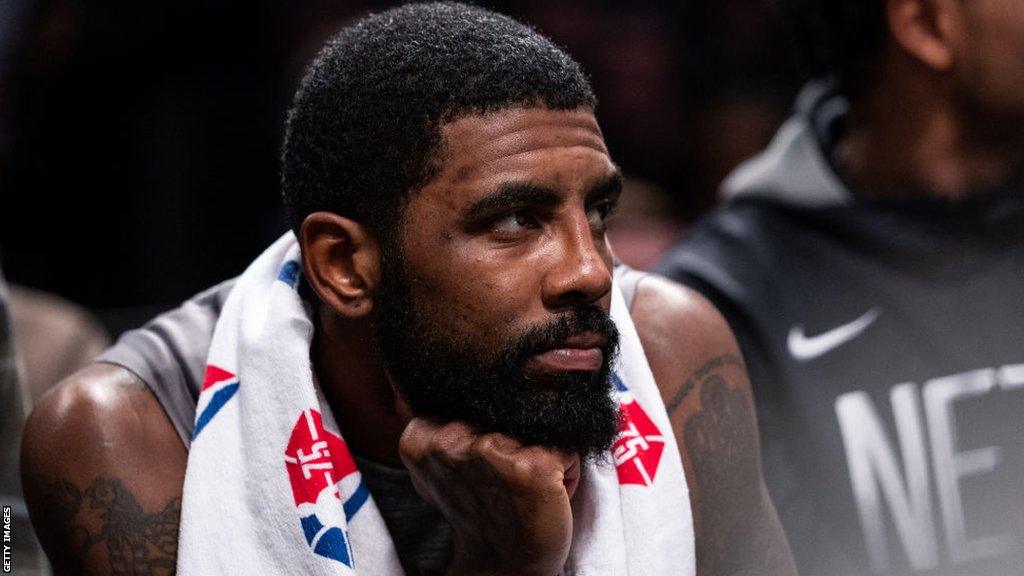 Brooklyn Nets guard Kyrie Irving sits on the bench