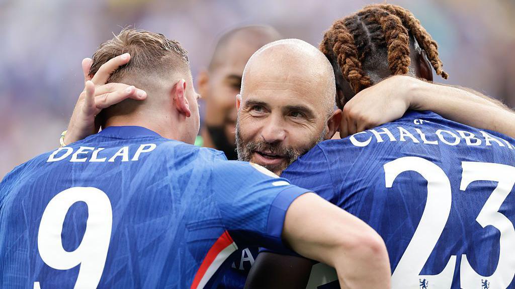 Chelsea manager Enzo Maresca hugs Liam Delap and Trevoh Chalobah after winning the Club World Cup