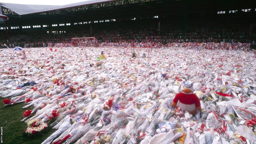 Flowers cover the Anfield pitch in front of the Kop in the wake of the Hillsborough disaster