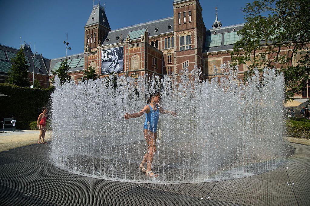 A girl cools down in a fountain in the Netherlands