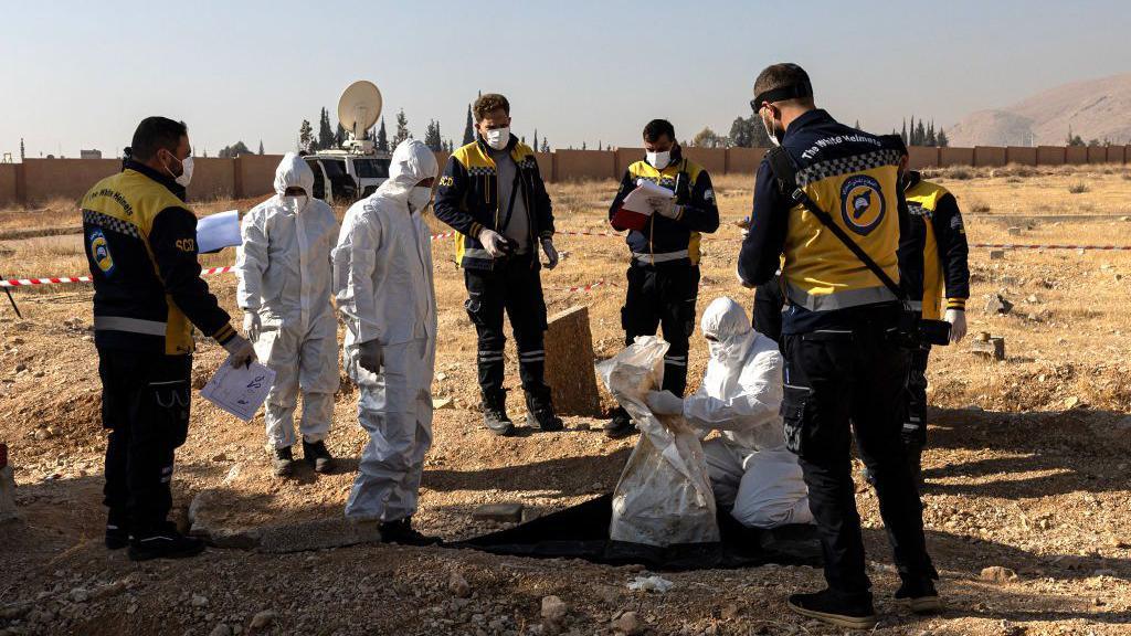 White Helmets rescuers recover human remains from a mass grave near Baghdad Bridge, near Adra, north-west of Damascus. Photo: 17 December 2024