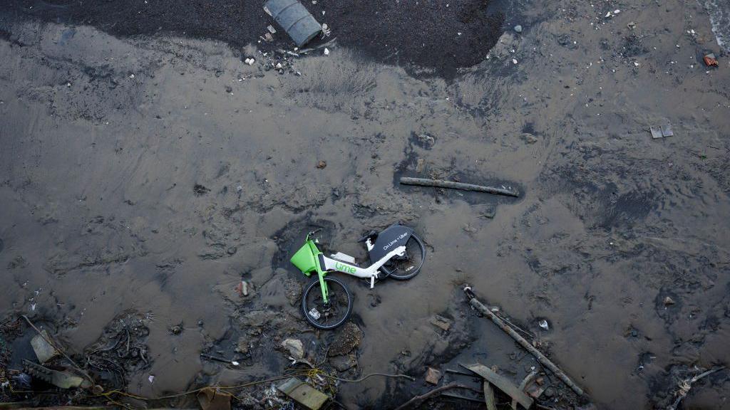 Dumped waste and washed-up litter lies at Blackwall Point the Greenwich Peninsular foreshore of the Thames river at low-tide, on 18th February 2025, in London, England