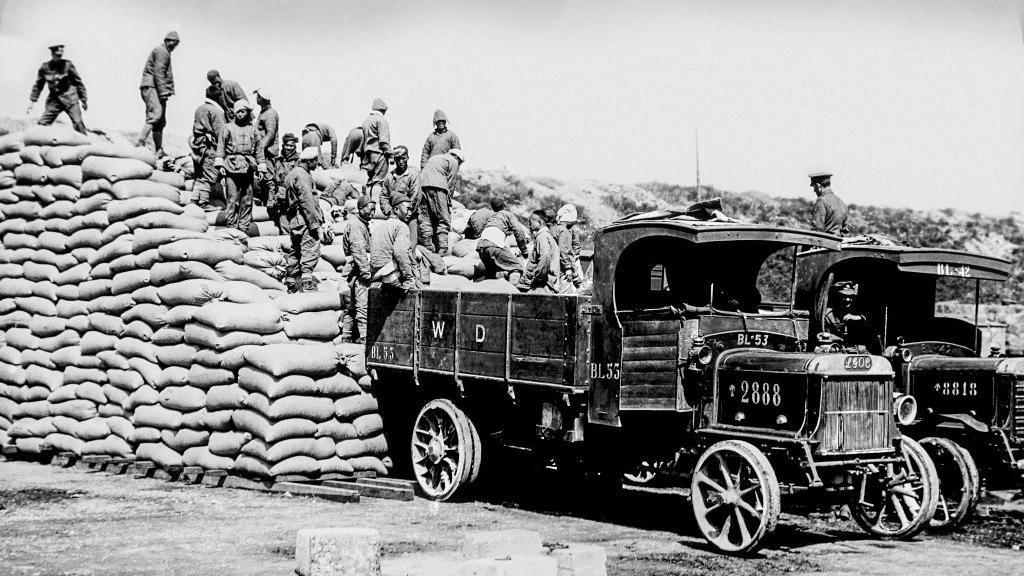 Magic Lantern Slide depicting men of the Chinese Labour Corps stacking sacks of corn at Boulogne during World War One in Boulogne, France.