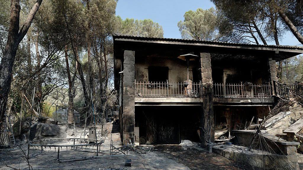 This picture shows a burned-out home following a devastating wildfire in Pelayos de la Presa, 65 kilometers west of Madrid