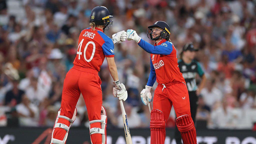 Amy Jones and Danni Wyatt-Hodge of England fist bump during their match against New Zealand.