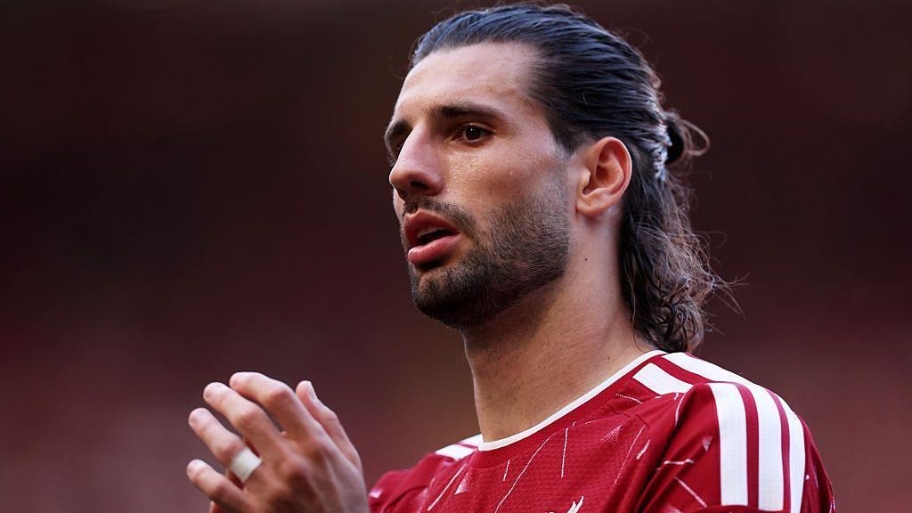 Dominik Szoboszlai claps in a Liverpool shirt