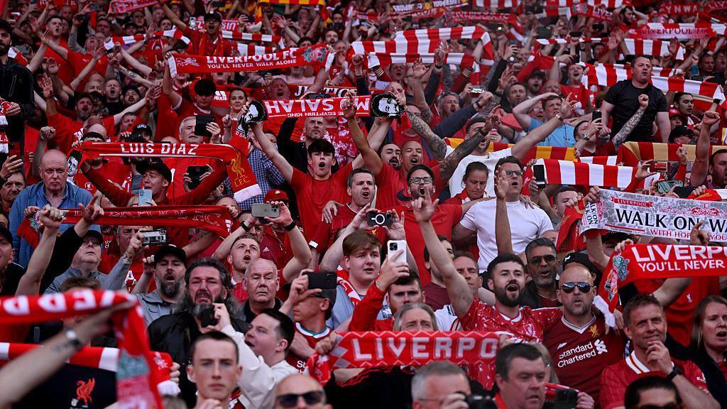 Fans celebrating after Liverpool named champions of the Premier League.