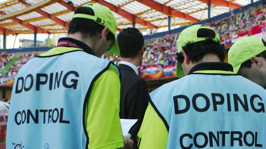 Doping control officers at a football match