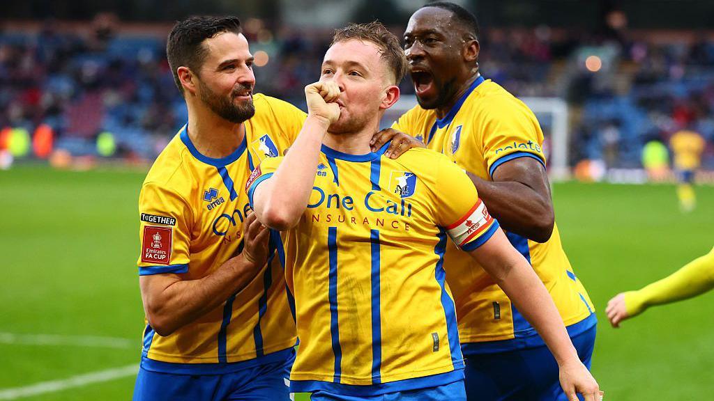 Louis Reed celebrates in front of the Mansfield Town fans after scoring against Burnley.