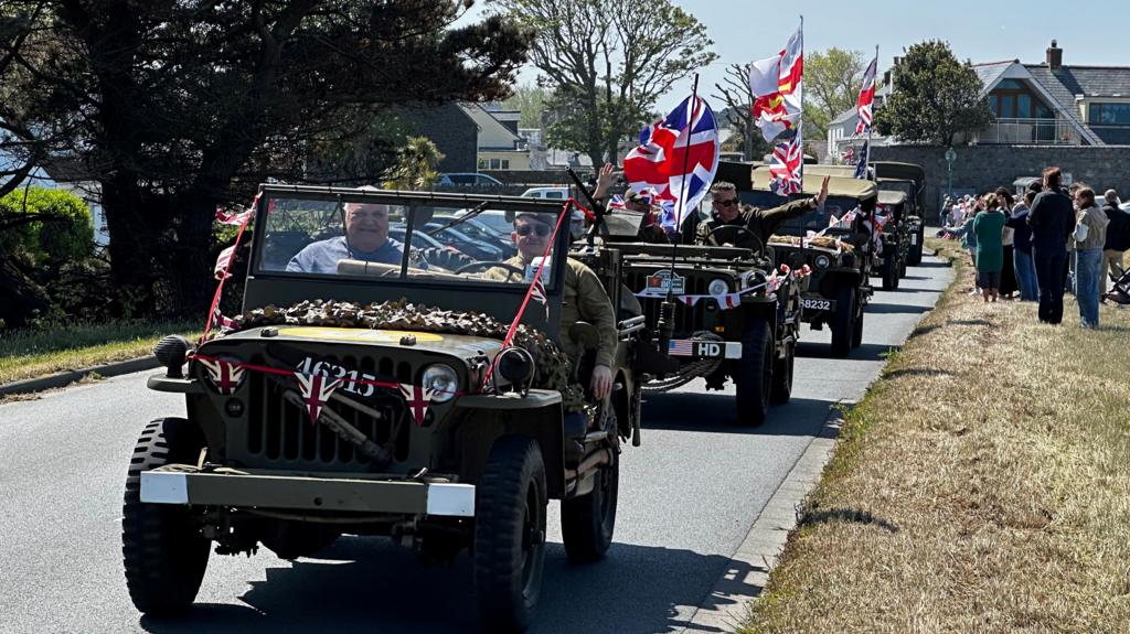 WW2 military vehicles adorned with flags
