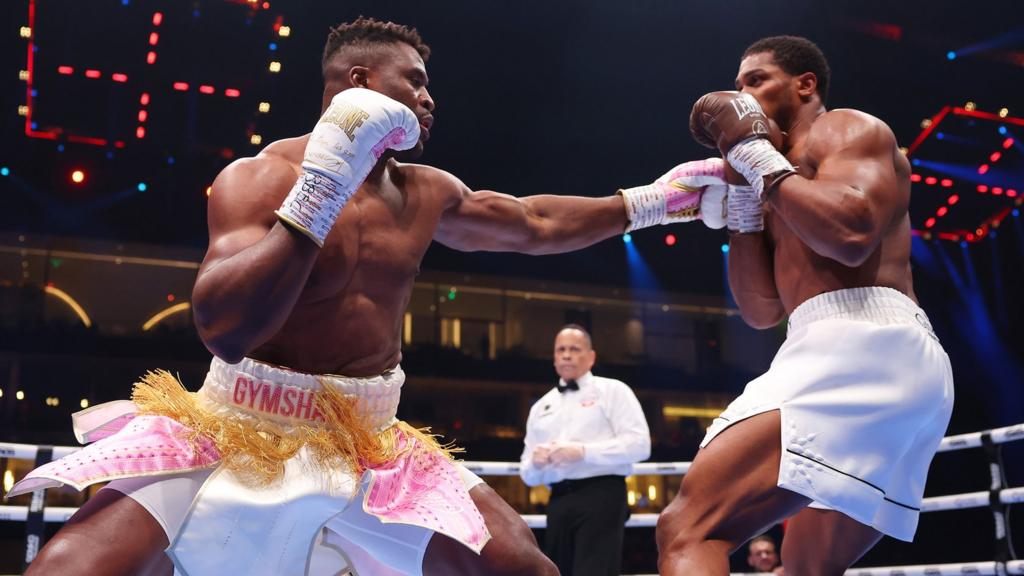 Francis Ngannou is punched by Anthony Joshua