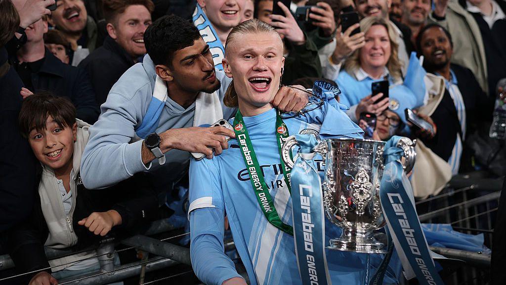 Erling Haaland celebrates winning the 2025-26 EFL Cup with Manchester City supporters