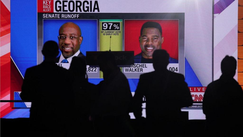 Supporters of Reverend Raphael Warnock attend an election night party