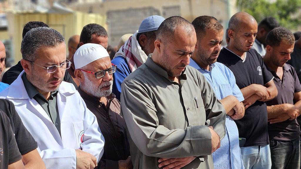 Palestinians gather to perform funeral prayer for Palestinian father Dr. Hamdi Al-Najjar, who lost nine of his children in an Israeli airstrike on the southern Gaza city of Khan Yunis.