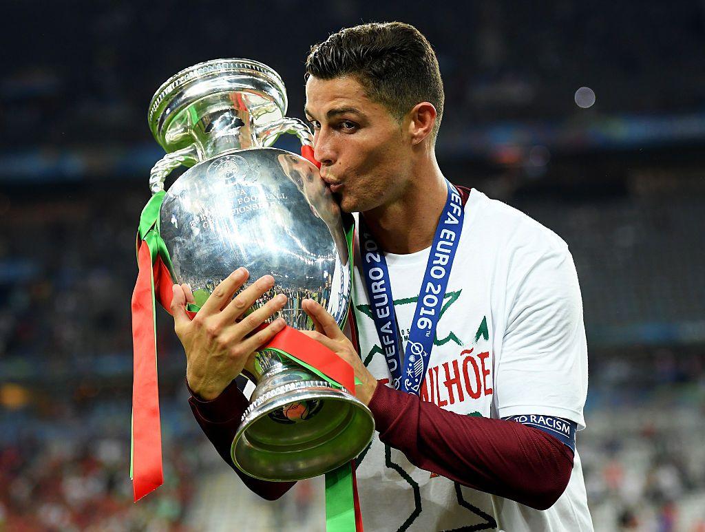 Cristiano Ronaldo of Portugal kisses the Henri Delaunay trophy to celebrate after their 1-0 win against France in the UEFA EURO 2016 Final match between Portugal and France at Stade de France on July 10