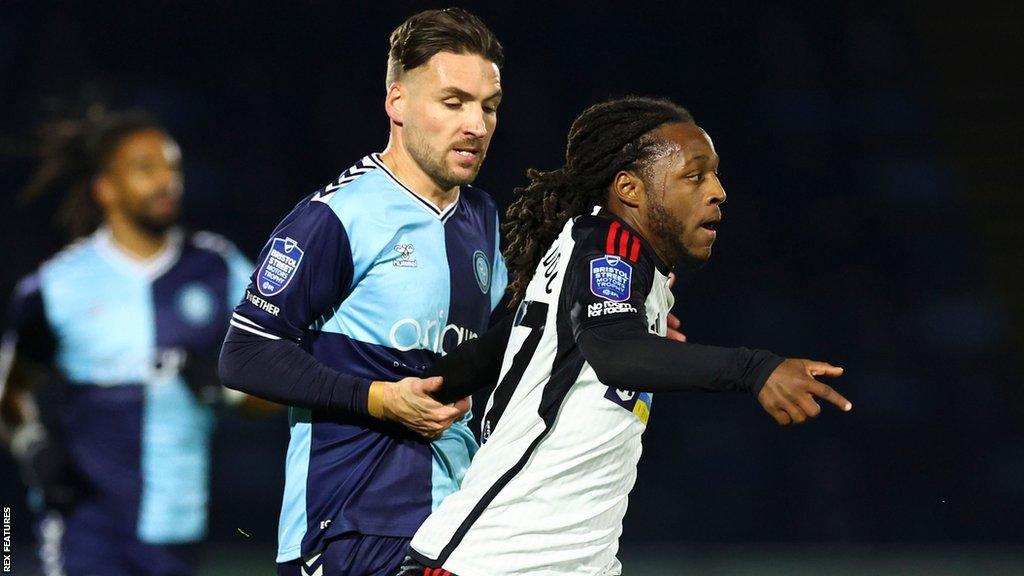 Luke Leahy tries to challenge Fulham's Imani Lanquedoc