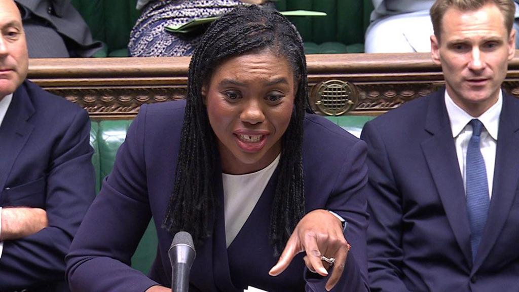 Kemi Badenoch speaking in the Commons, pointing forward with her left hand