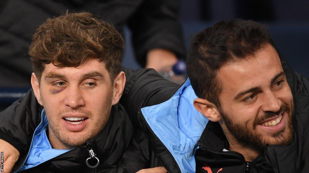 John Stones and Bernardo Silva embrace on bench