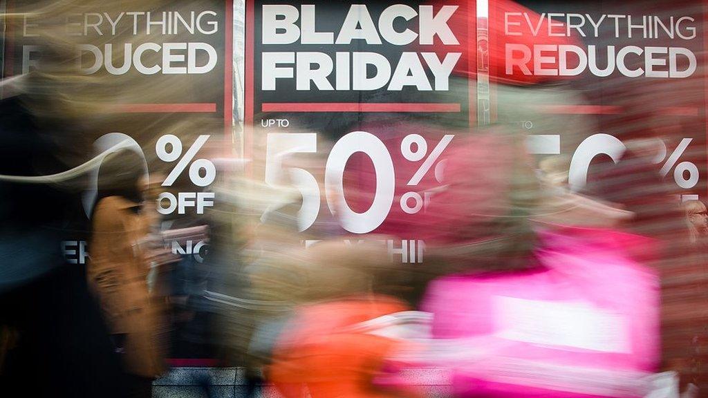 Retail stores display 'Black Friday' advertisements and banners on Oxford Street in central London