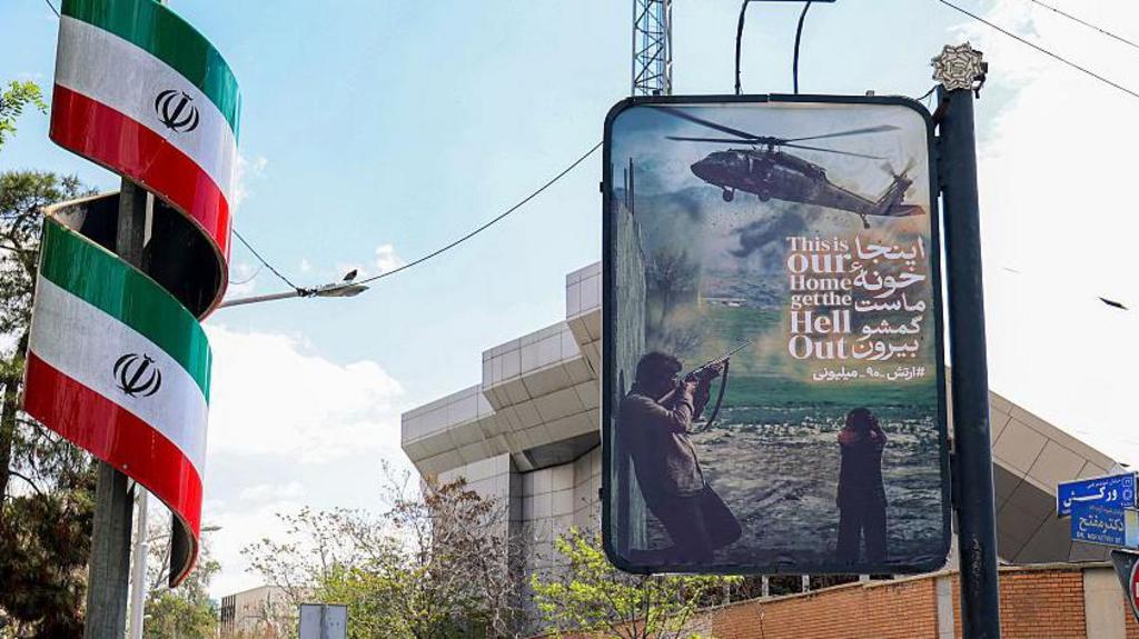 A poster in Tehran on Monday morning, reading (in English): "This is our home, get the hell out"