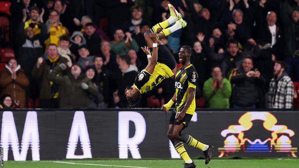 Emmanuel Dennis celebrates with a backflip