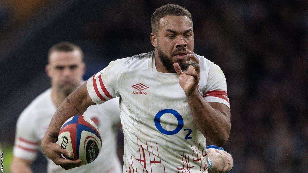 Ollie Lawrence runs with the ball, playing for England