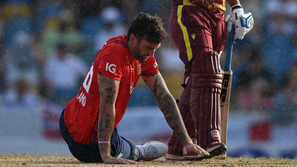 Reece Topley lays on the turf after getting injured